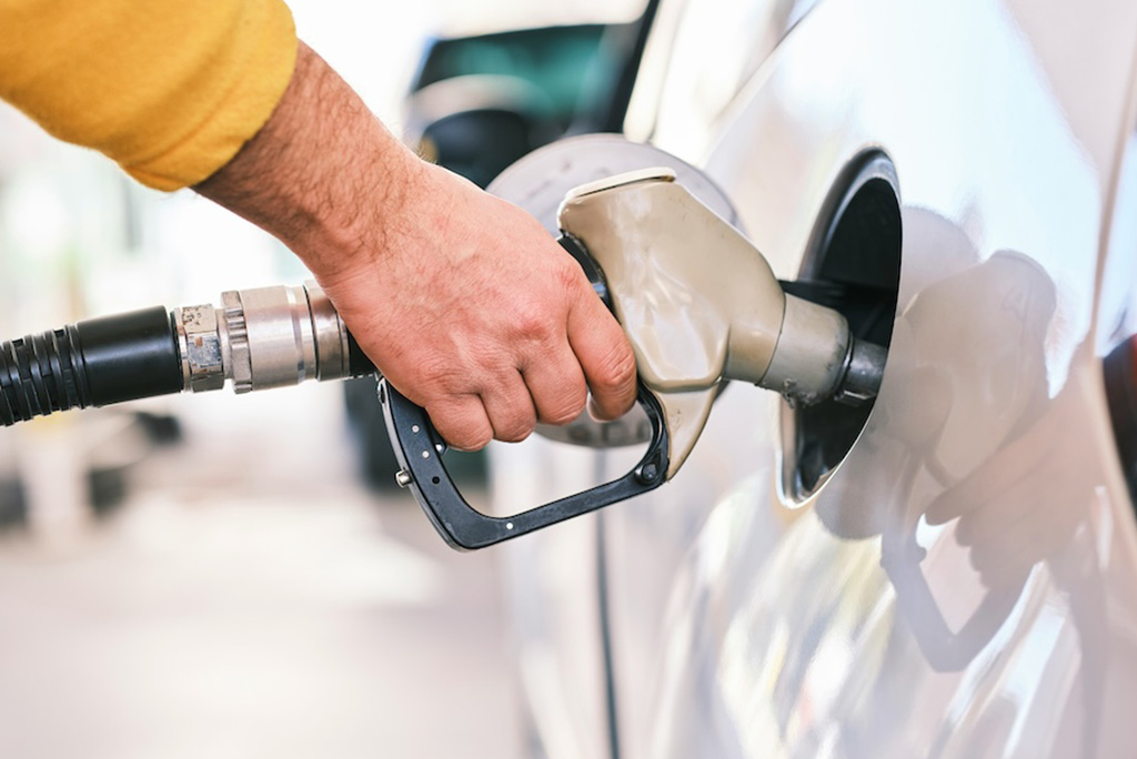person pumping gas into their car